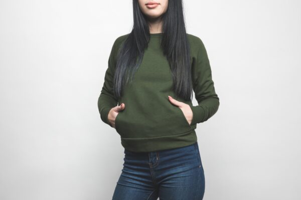 young woman in blank green sweatshirt on white